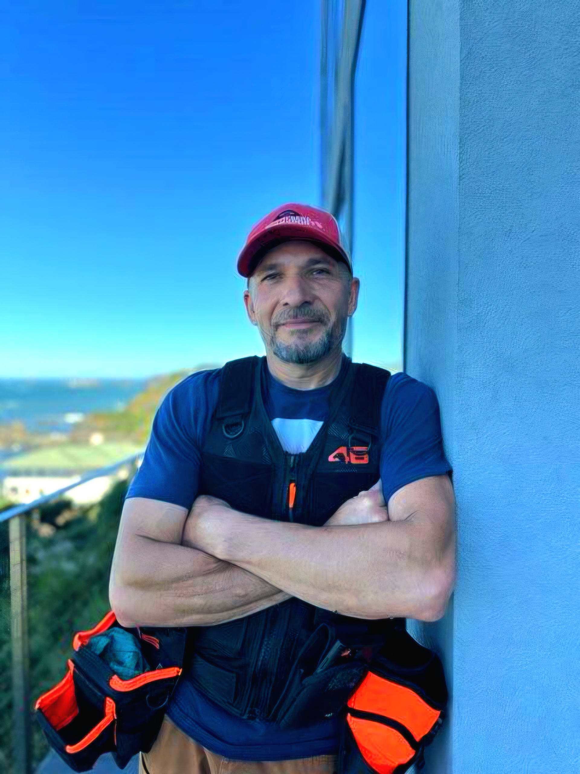 Paul Lopez, owner of Brookings Window Cleaning, on a coastal balcony overlooking the Southern Oregon coast